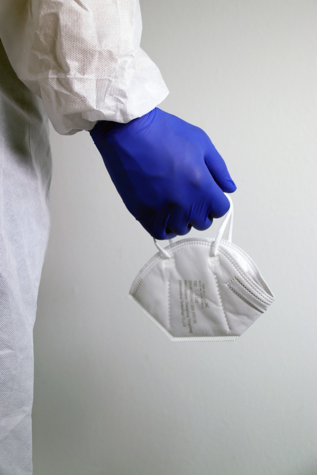 person-in-white-dress-shirt-holding-gray-pants-f2qhswzby44