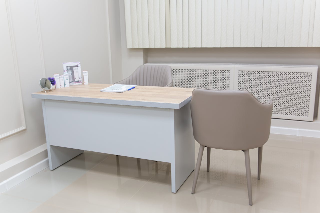 Minimalist medical office with a modern desk and chairs, perfect for healthcare settings.